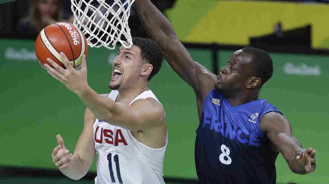 United States' Klay Thompson avoids France's Charles Kahudi for a layup Sunday. The U.S. won their third straight close game, 100-97, as Thompson led the way with 30 points.