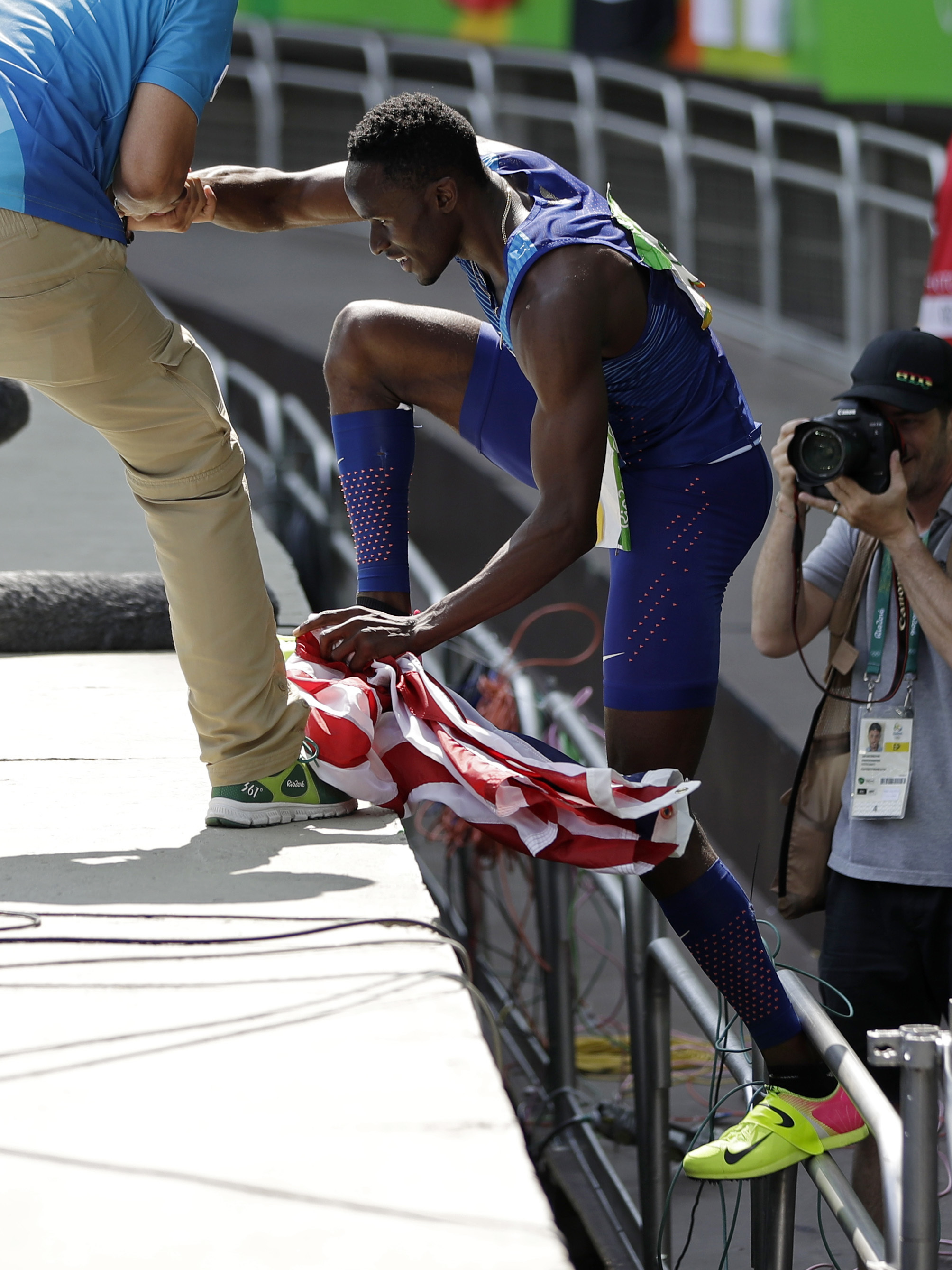 American Will Claye climbs back to the track after proposing to his girlfriend in the stands. He went into the crowd to propose right after he won the silver medal in the triple jump on Tuesday.