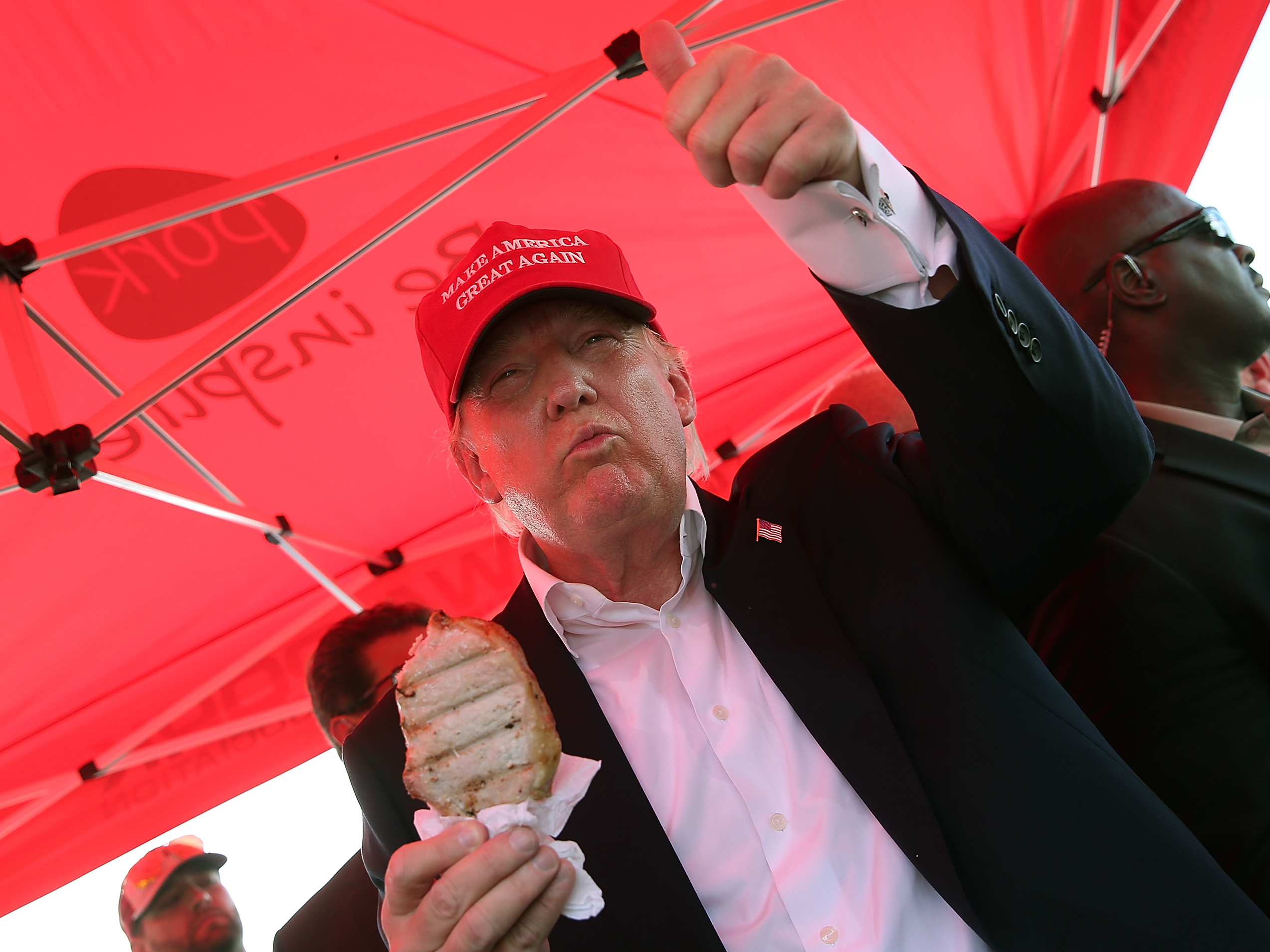 Republican presidential candidate Donald Trump eats a pork chop on a stick at the 2015 Iowa State Fair.