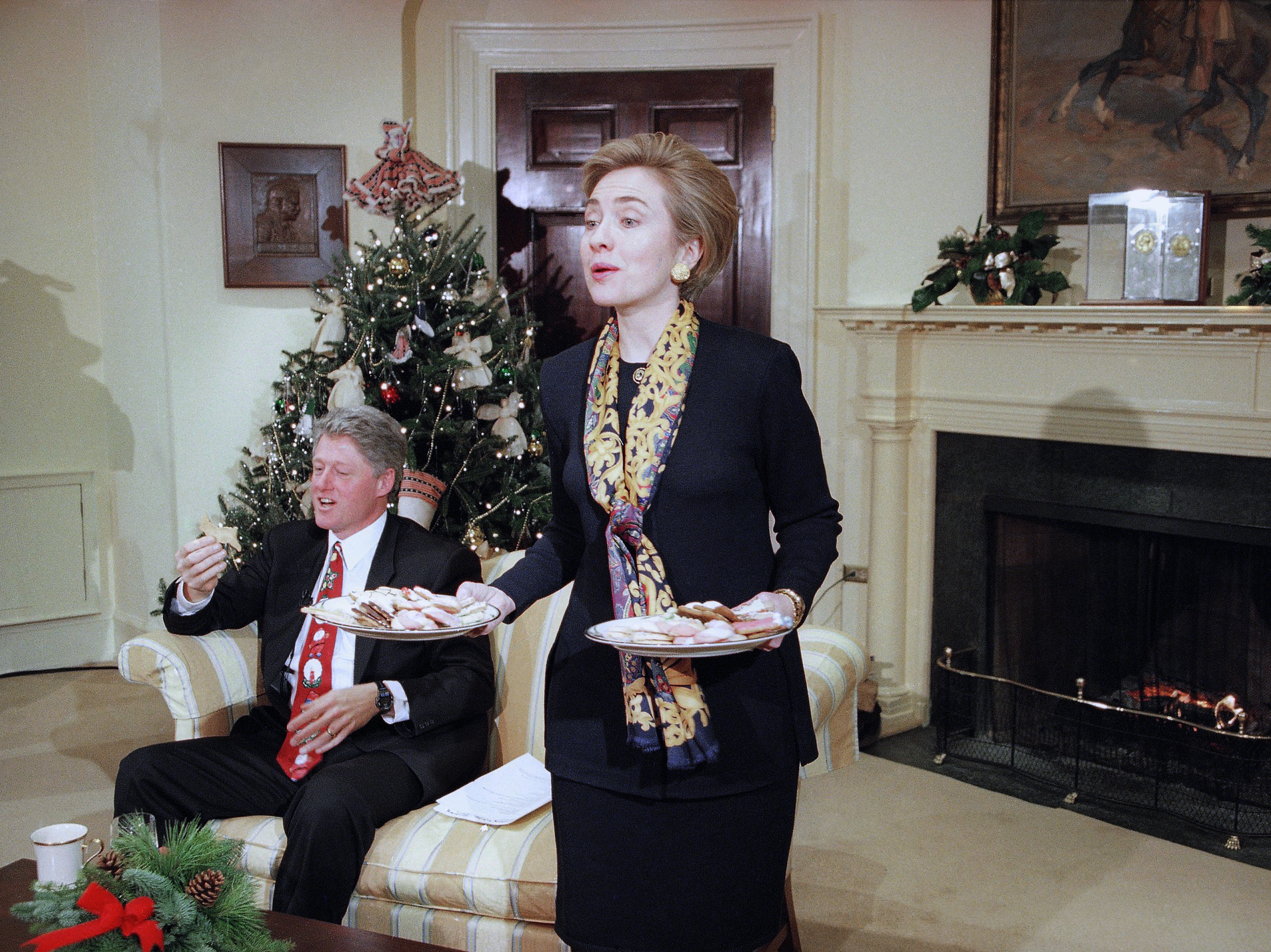 First lady Hillary Clinton offers cookies to the Arkansas press corps during an interview with President Bill Clinton in the Roosevelt Room at the White House in 1993.