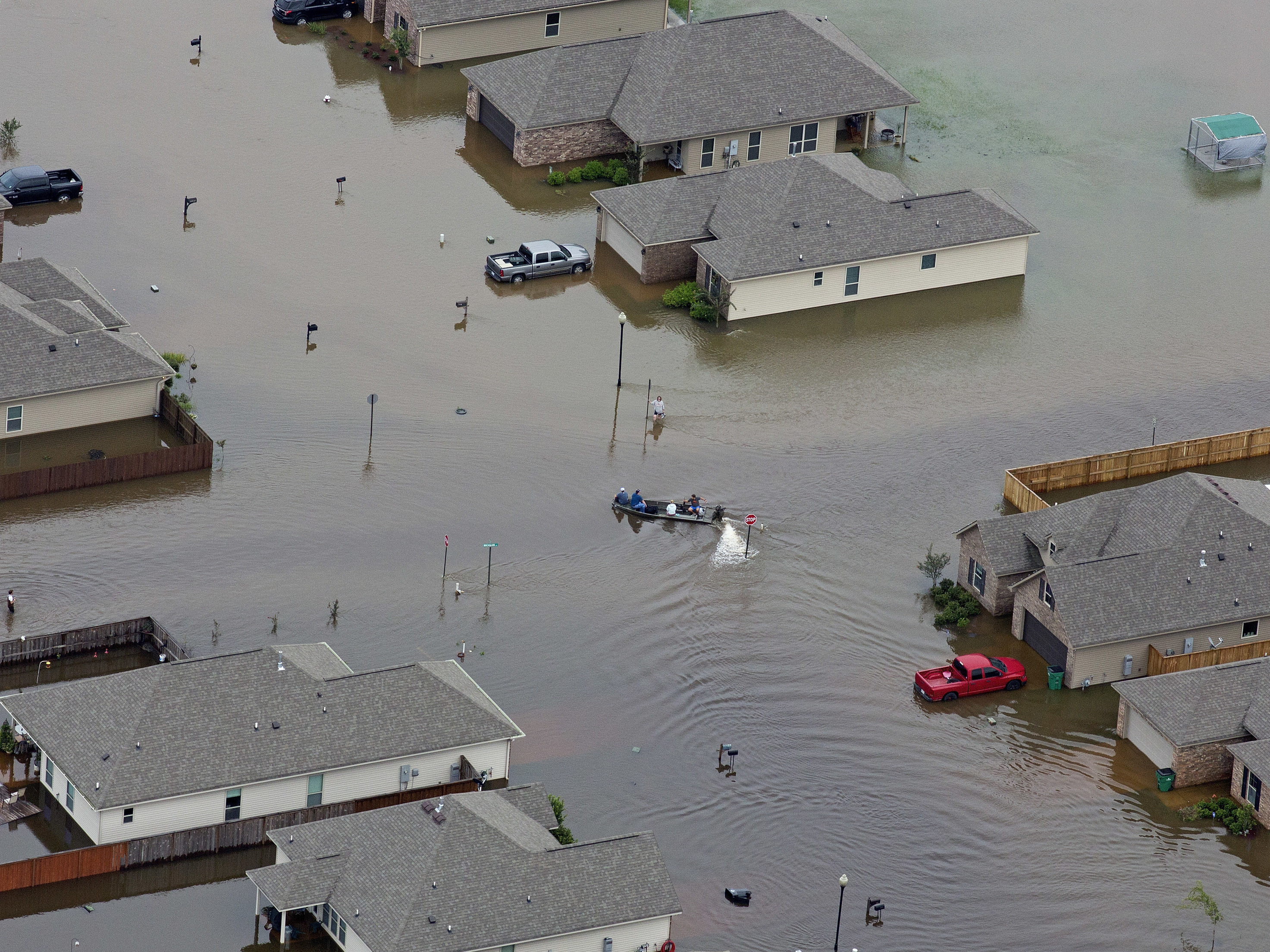 A boat floats between flooded homes in Hammond, La., after heavy rains inundated the southeastern part of the state. (AP)