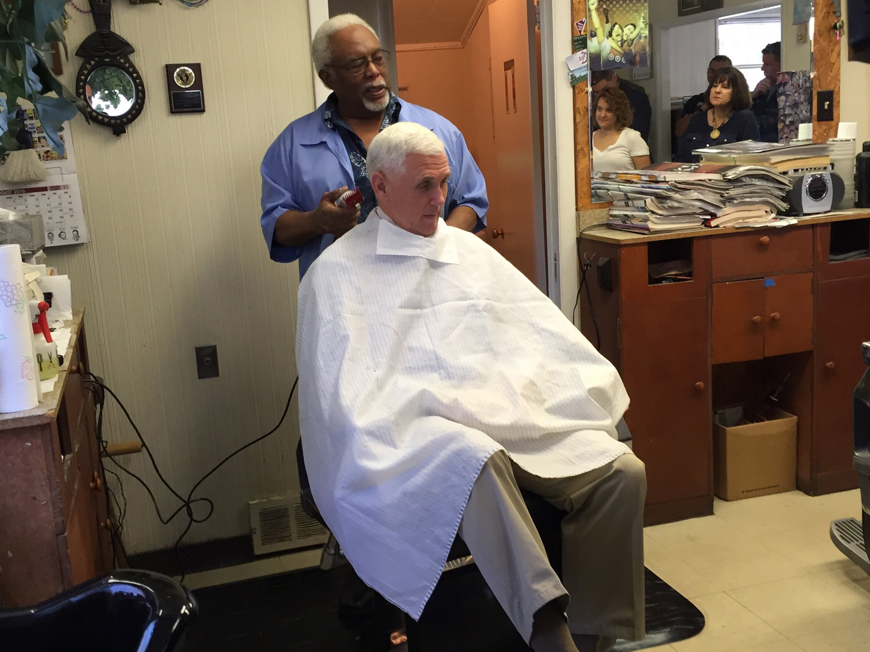 Indiana Gov. Mike Pence, the GOP vice presidential nominee, gets his hair trimmed by barber Henry Jones in Norristown, Pa.