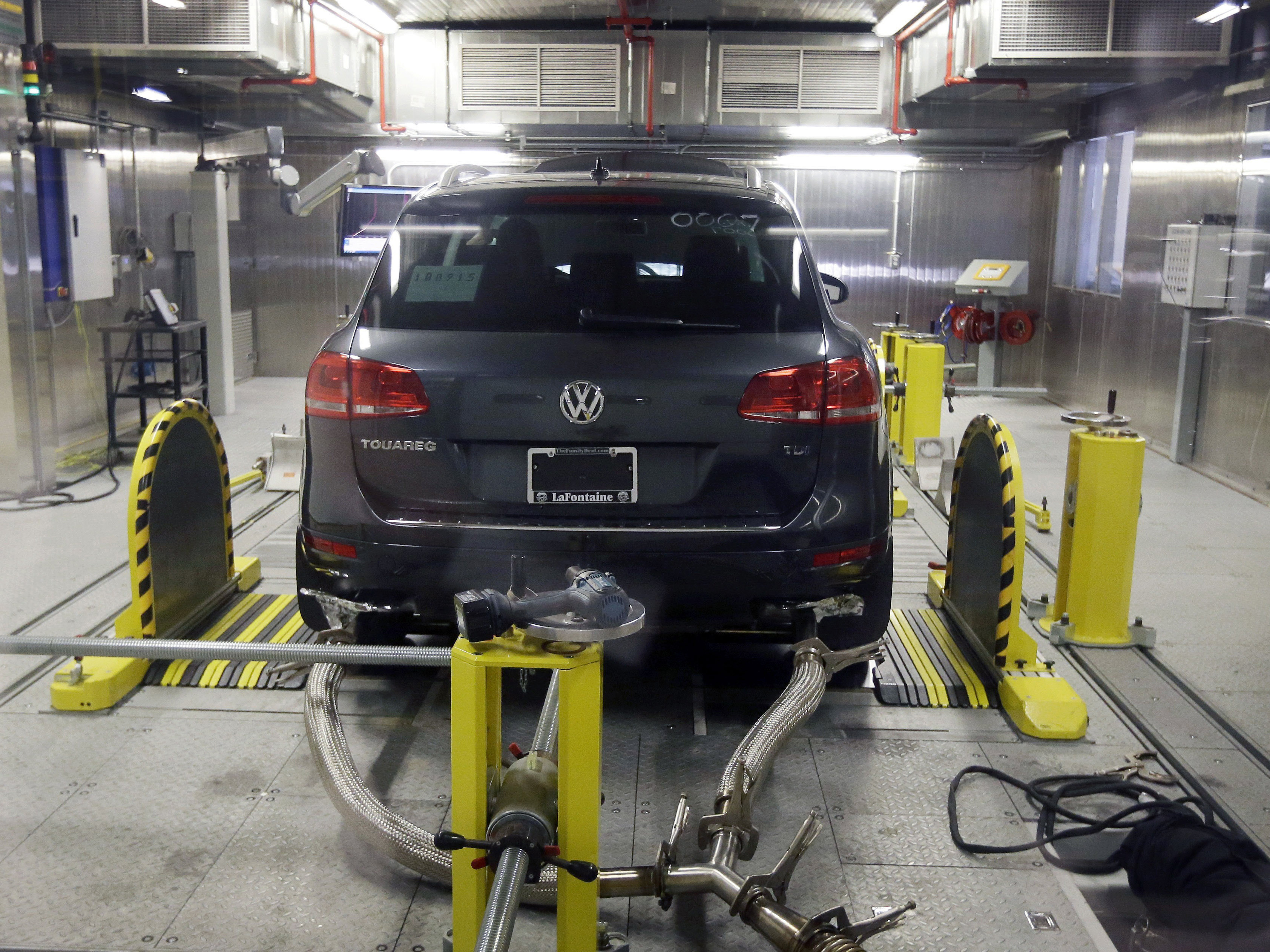A Volkswagen Touareg diesel is seen being tested at a federal facility in Michigan last year. Volkswagen has reached a tentative deal with its U.S. dealers to compensate them for plummeting sales as a result of the company's emissions cheating scandal.