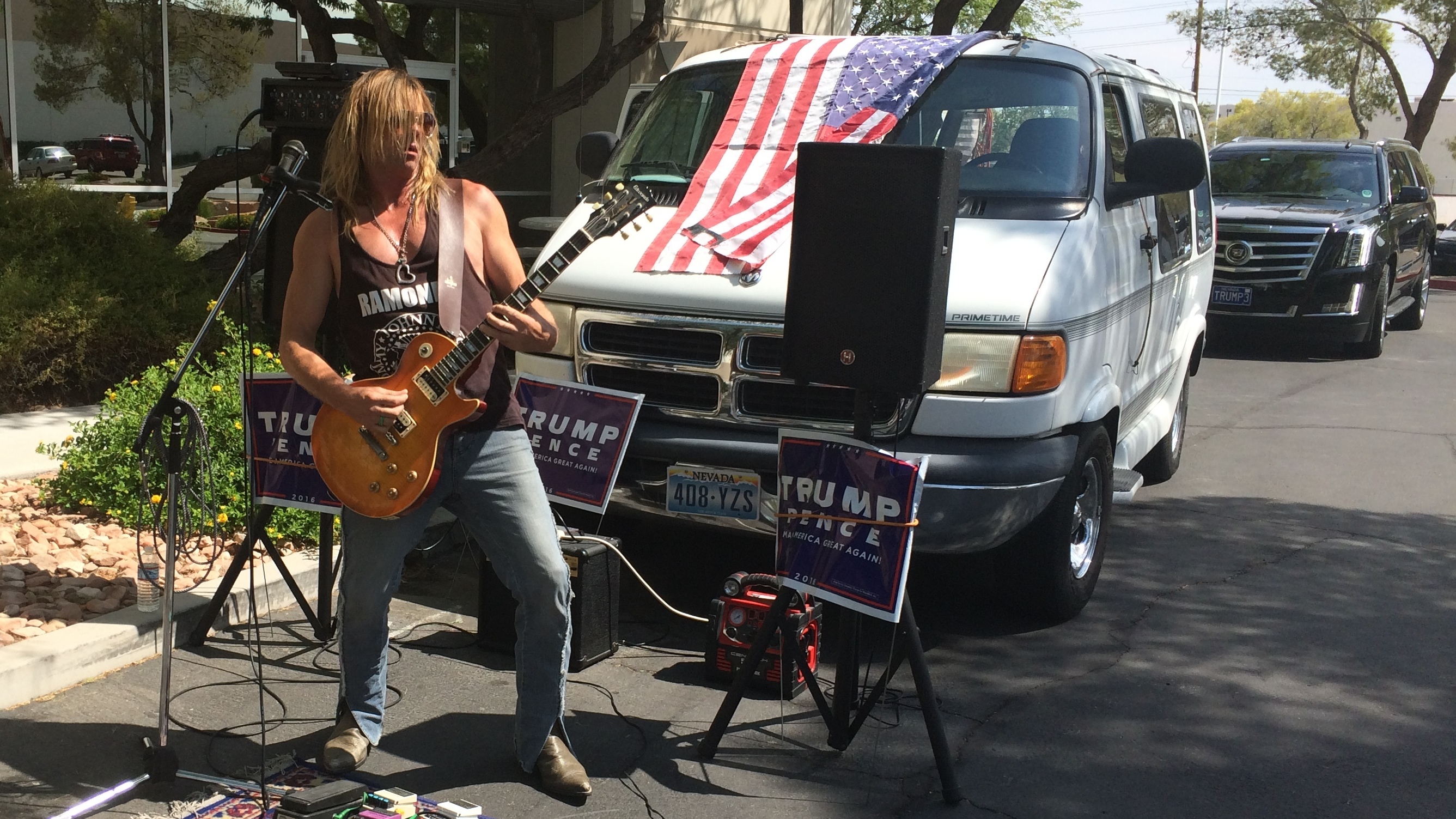 Steven Boz performs outside of a Trump campaign office. He says he loves Trump's "attitude."