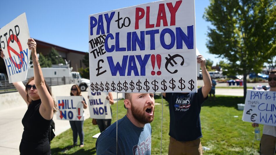 Protesters shout as people wait to enter a Hillary Clinton campaign event last month in Nevada. Donald Trump is calling for a special prosecutor to investigate allegations of pay-to-play by Clinton, but the history of independent counsels and special prosecutors suggests they don't always remove politics from the process. (Josh Edelson/AFP/Getty Images)