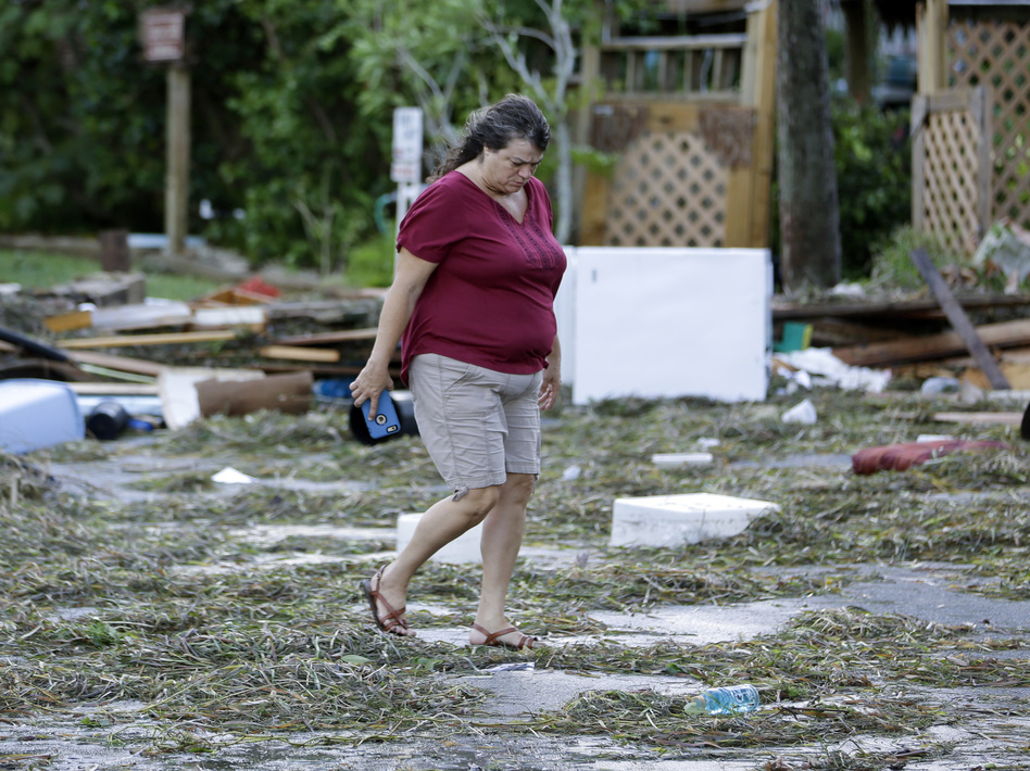 A resident checks on damage from Hurricane Hermine in Cedar Key, Fla. Hermine was downgraded to a tropical storm after it made landfall. Authorities say the storm could regain hurricane status by the time it hits the Mid-Atlantic states by Monday. (John Raoux/AP)