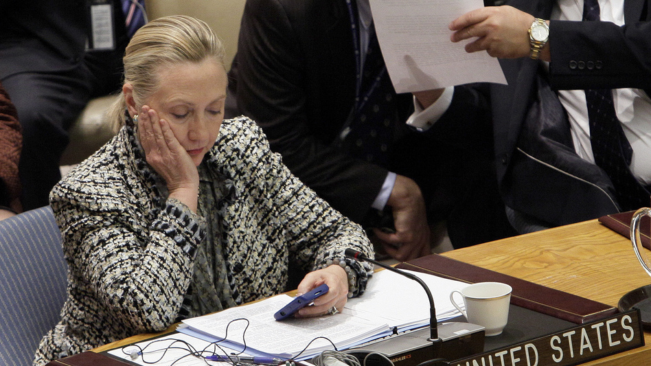 Hillary Clinton checks her phone after addressing the Security Council at the United Nations as secretary of state in 2012. (Richard Drew/AP)