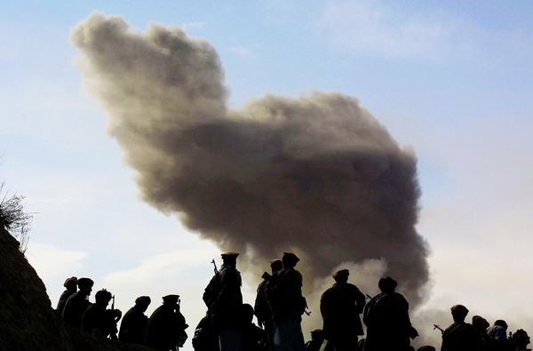 Northern Alliance soldiers, aligned with the U.S., watch as American warplanes drop bombs on the Taliban on Nov. 19, 2001, around the city of Kunduz, Afghanistan. The U.S.-led coalition quickly drove the Taliban from power, but 15 years later, the Americans are still helping the Afghan army battle the Islamist radicals.