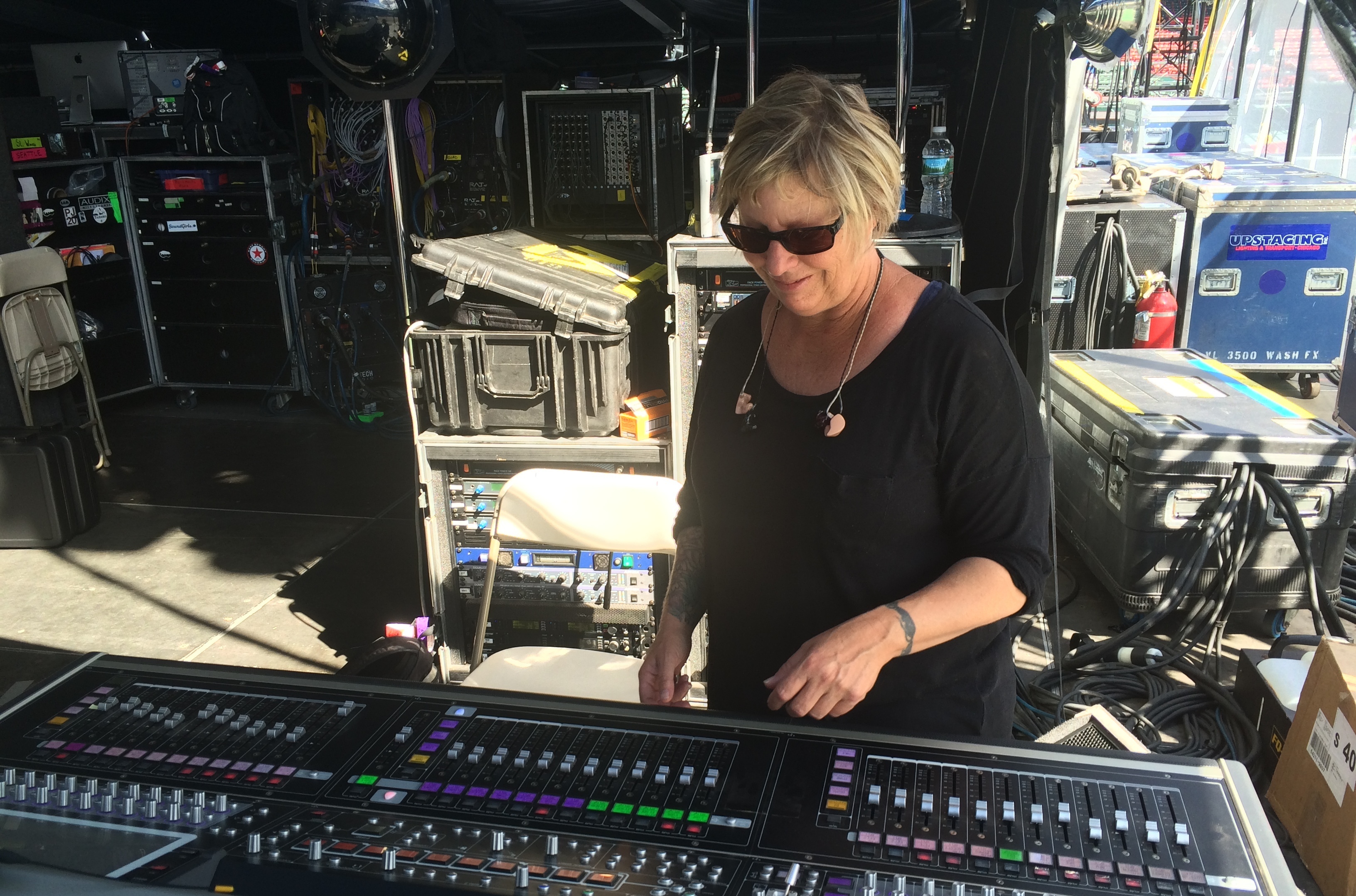 Karrie Keyes stands at her soundboard at a show at Boston's Fenway Park in August 2016. From here, she communicates with the members of Pearl Jam to get the monitor mix just right. (Caroline Losneck)