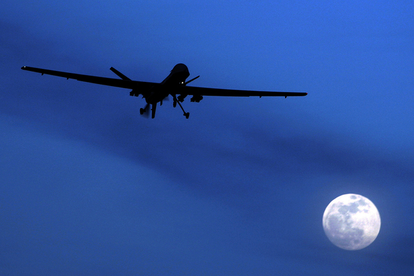 A U.S. Predator drone flies over Kandahar Air Field, southern Afghanistan, on a moonlit night in 2010. The U.S. military has increasingly turned to drones in Syria, Iraq and Afghanistan, where the military carries out airstrikes daily.