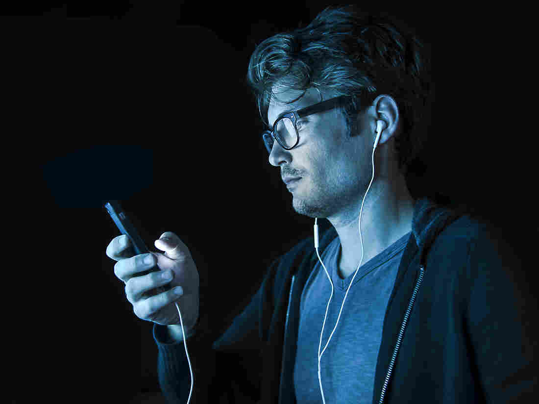 A man listens to an iPhone.