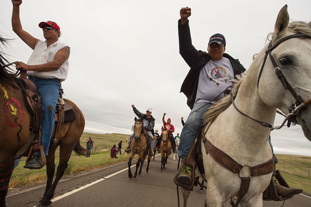 Protesters ride near the site of construction. The company building the pipeline says in court documents that it "is not destroying and has not destroyed any evidence or important historical sites."