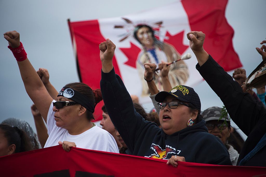 Native Americans march on Sunday to a sacred site they say was disturbed by bulldozers working on the Dakota Access Pipeline, near an encampment where hundreds of people have gathered to join the Standing Rock Sioux Tribe's protest.