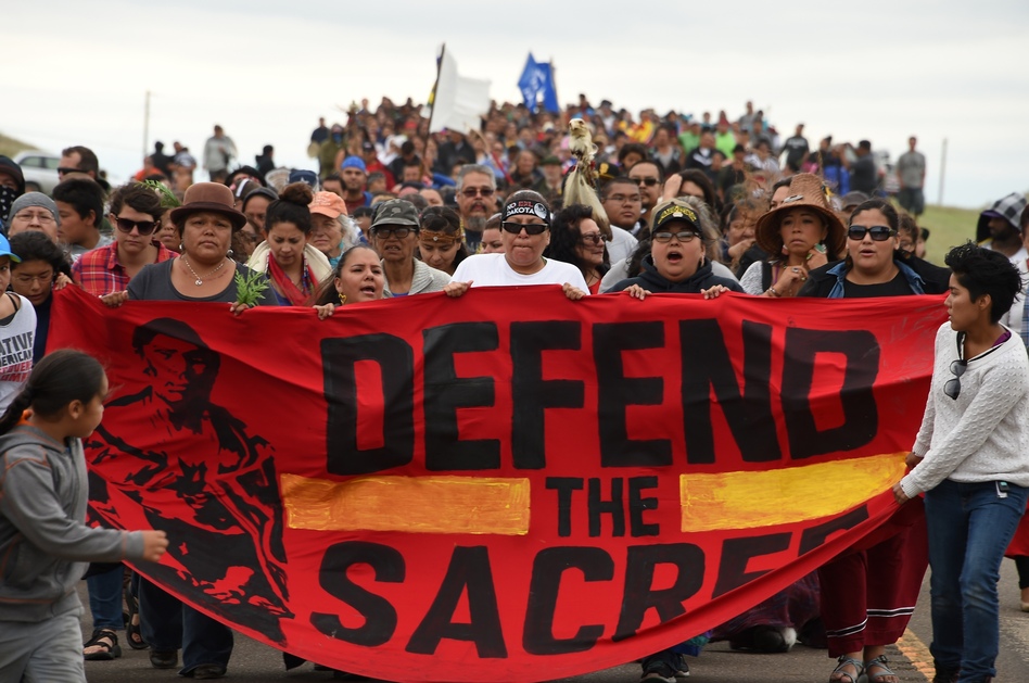 Native Americans march to a sacred site on Sunday that they say was disturbed by bulldozers working on the Dakota Access Pipeline, near the encampment where hundreds of people have gathered to join the Standing Rock Sioux tribe's protest. (Robyn Beck/AFP/Getty Images)