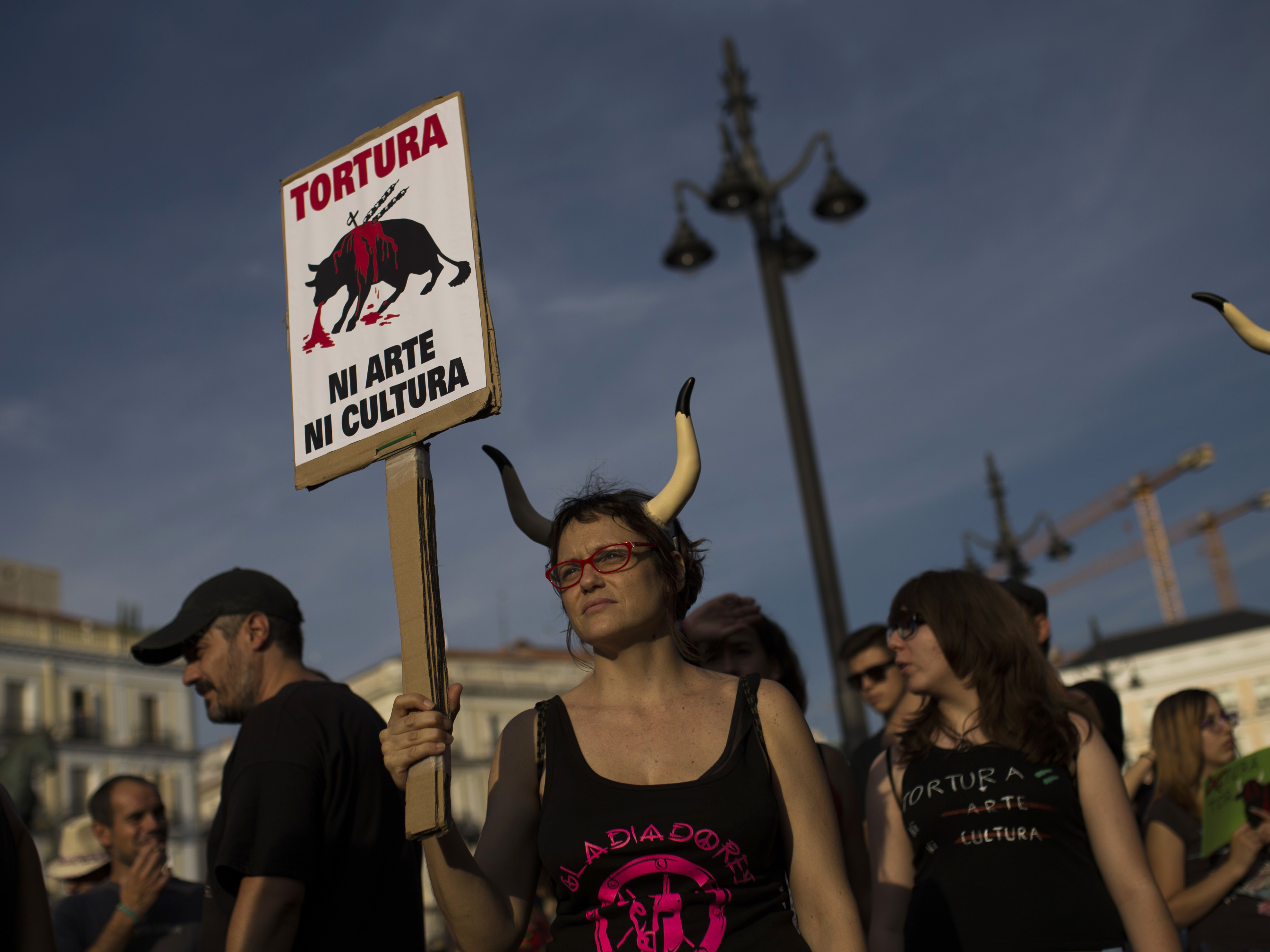 People listen to speeches during a protest against bullfighting in Madrid on Saturday. The placard reads in Spanish: "Torture is neither art nor culture."