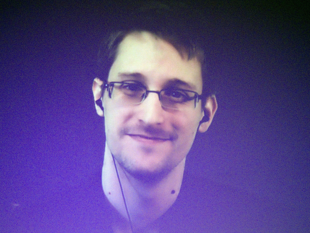 Edward Snowden, who is in Moscow, is seen on a giant screen during a live video conference for an interview as part of an Amnesty International event in Paris in December 2014. The House Permanent Select Committee on Intelligence published a summary report accusing Snowden of causing &quot;tremendous damage to U.S. national security.&quot; (AP)