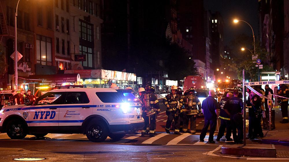 Police officers and firefighters respond to an explosion on Saturday at 23rd Street and 7th Avenue in the Chelsea neighborhood of New York City. Authorities say more than two dozen people have been taken to hospitals with injuries, none of which are thought to be life threatening. (Getty Images)