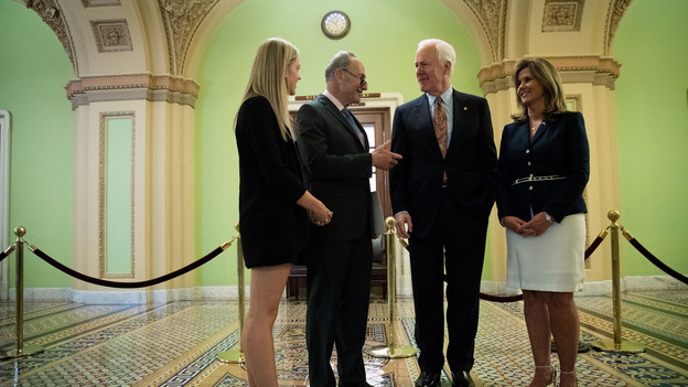 Sens. Chuck Schumer, D-N.Y., and John Cornyn, R-Texas, speak with Kaitlyn (left) and Terry Strada — whose husband, Thomas, died in the Sept. 11 attacks — after a May 17 news conference concerning the Justice Against Sponsors of Terrorism Act in Washington. (Image credit: Getty Images)