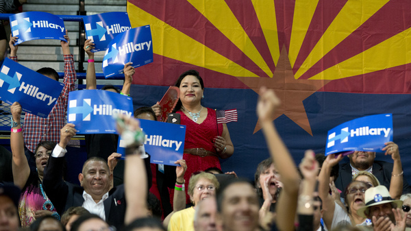 People in the audience cheer as Democratic presidential candidate Hillary Clinton speaks in Phoenix in March.