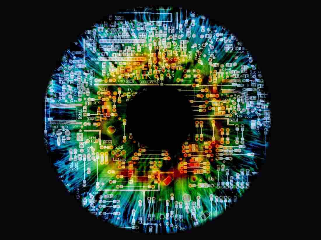 Composite image of a human eye and a circuit board.