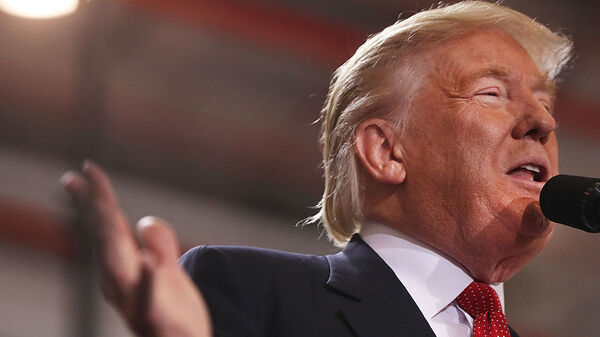 Donald Trump speaks to a large group of supporters at a Florida airport hangar on Tuesday night, the day after his first debate with Hillary Clinton.