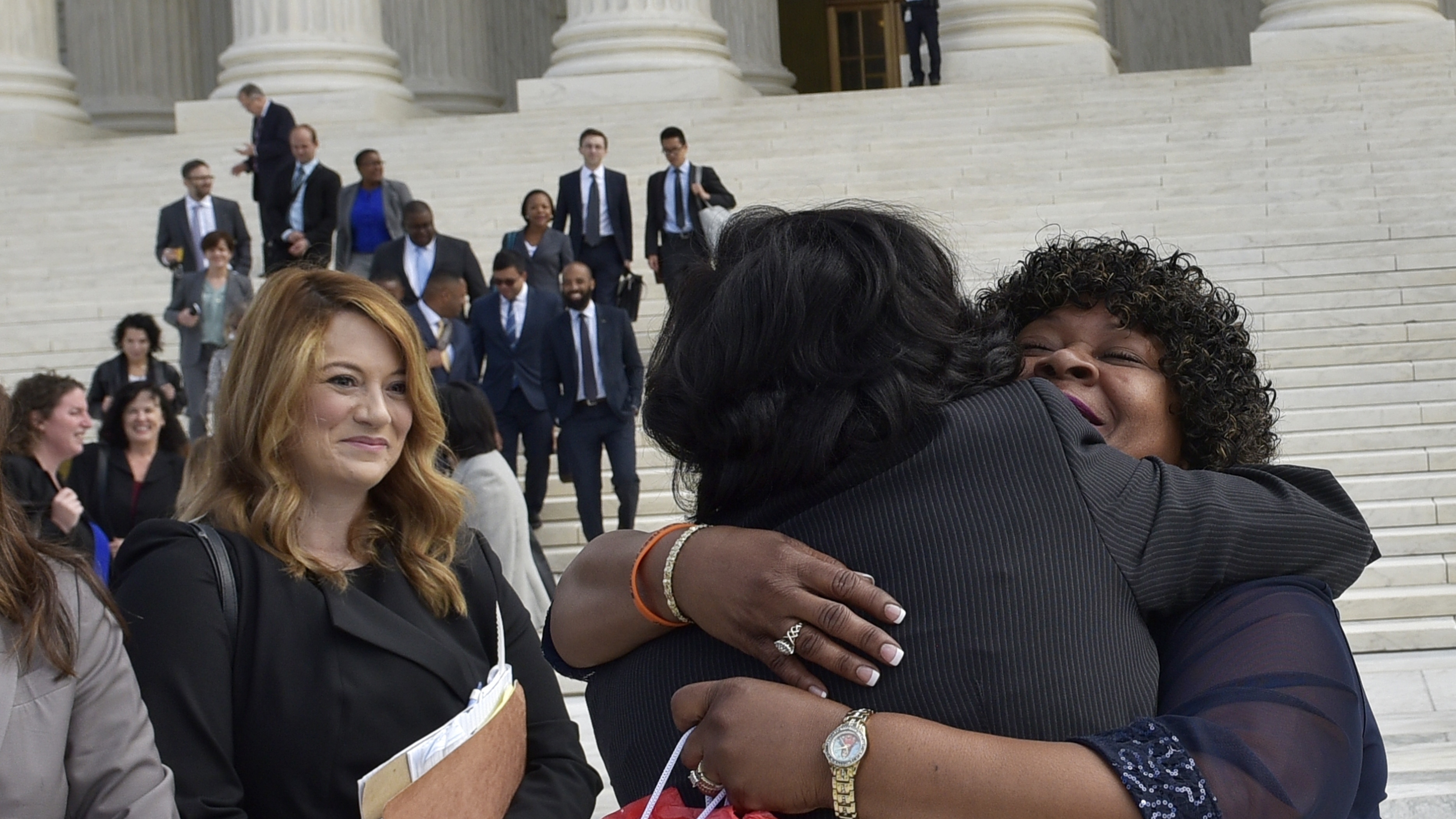Christina Swarns, center, the lead counsel for Duane Buck, is embraced by Buck's stepsister Phyllis Taylor, right, outside of the U.S. Supreme Court on Oct. 5 in Washington, D.C. (AFP/Getty Images)