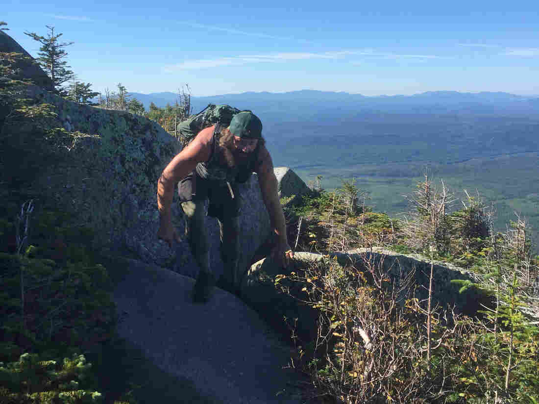 Marine Corps vet Daniel Dean climbs over a pink granite boulder on his way up Mount Katahdin. The trail stretches from Georgia to Maine, and usually takes about six months to complete.