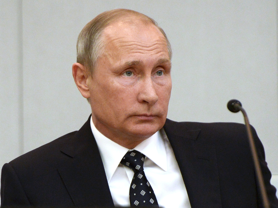 Russian President Vladimir Putin listens during the opening session of the newly elected State Duma, Russia's lower house of parliament, in Moscow. The U.S. blamed the Russian government for the hacking of American political sites and accused Moscow of trying to interfere with the upcoming presidential election. (Alexei Nikolsky/AP)
