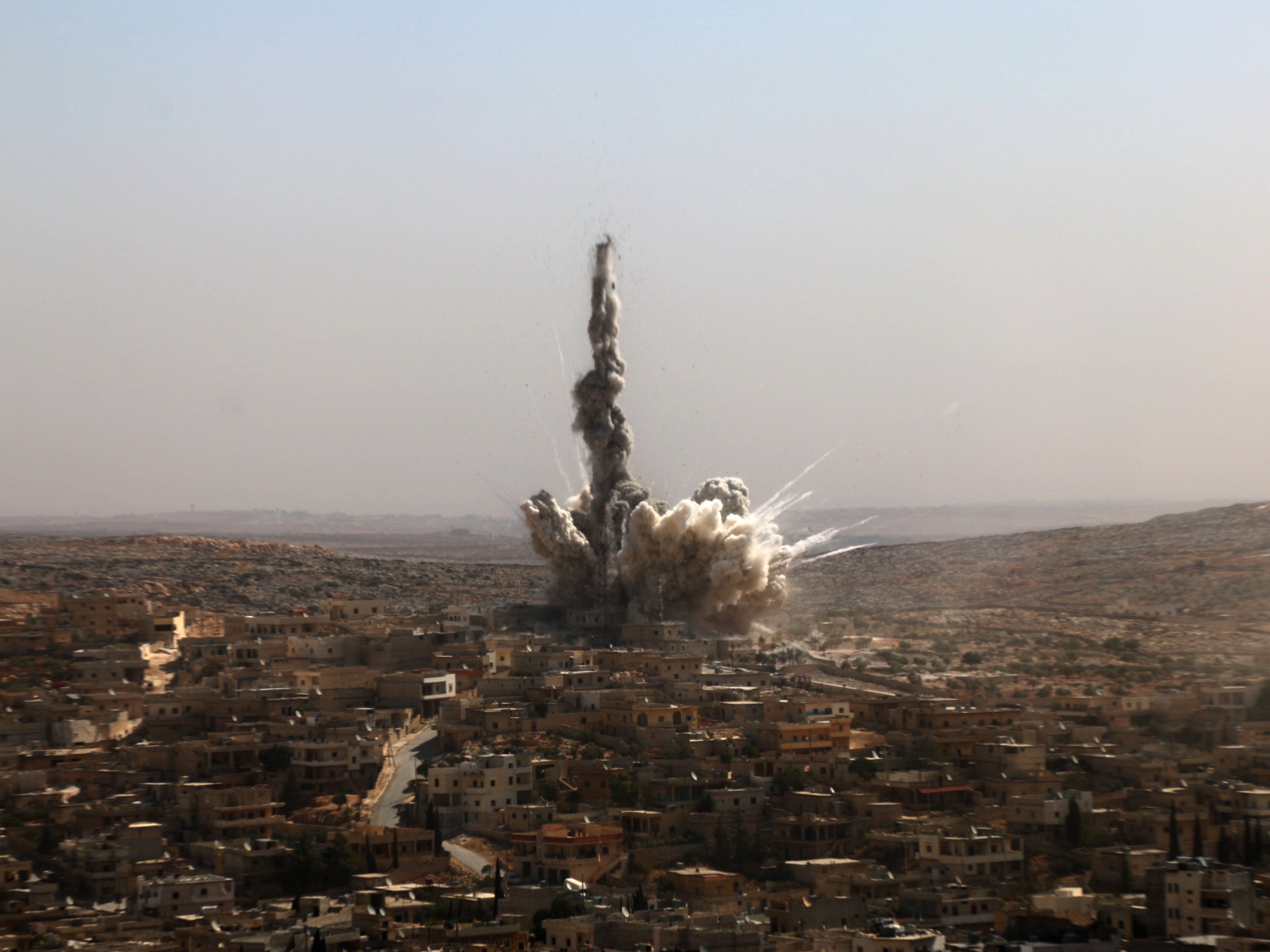 Smoke rises after a Russian Army aircraft bombed a residential area in the Darat Izza neighborhood of Aleppo on Oct. 4. (Getty Images)