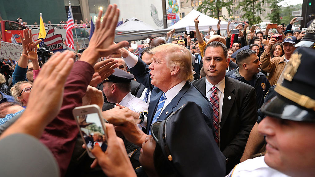 Donald Trump greets supporters outside of Trump Towers in Manhattan October 8, 2016 after a 2005 video revealed lewd comments Trump made about women. (Getty Images)
