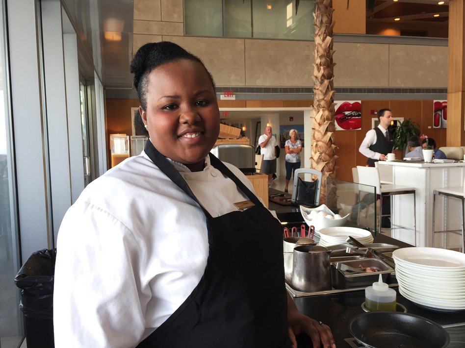 Florance Eloi works the omelet station at Hilton's Conrad Miami. By the time Eloi gave birth, a new company policy guaranteed her 10 weeks of fully paid parental leave. (Jennifer Ludden/NPR)