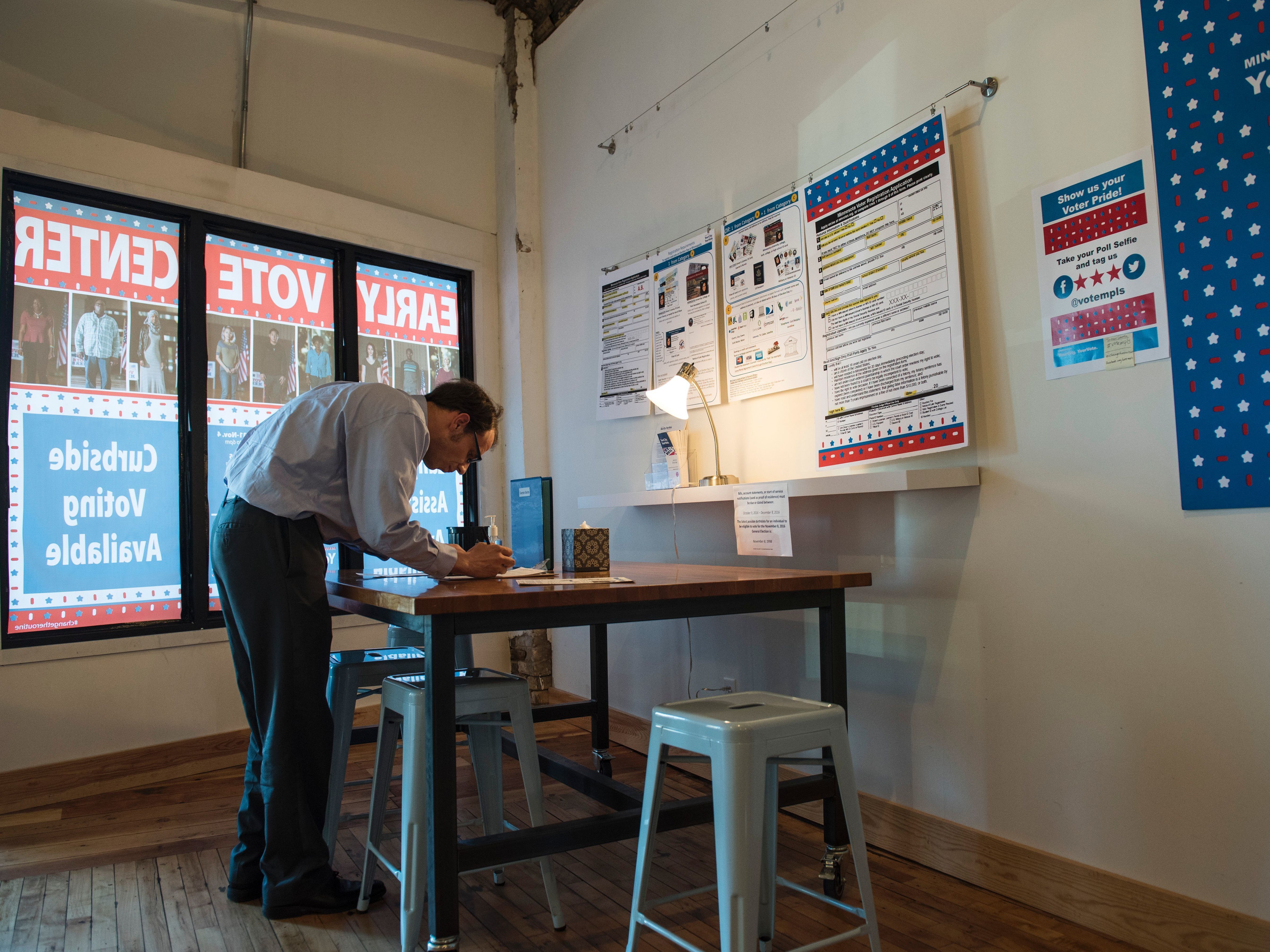 A man registers to vote at the Early Vote Center in Minneapolis on Oct. 5.
