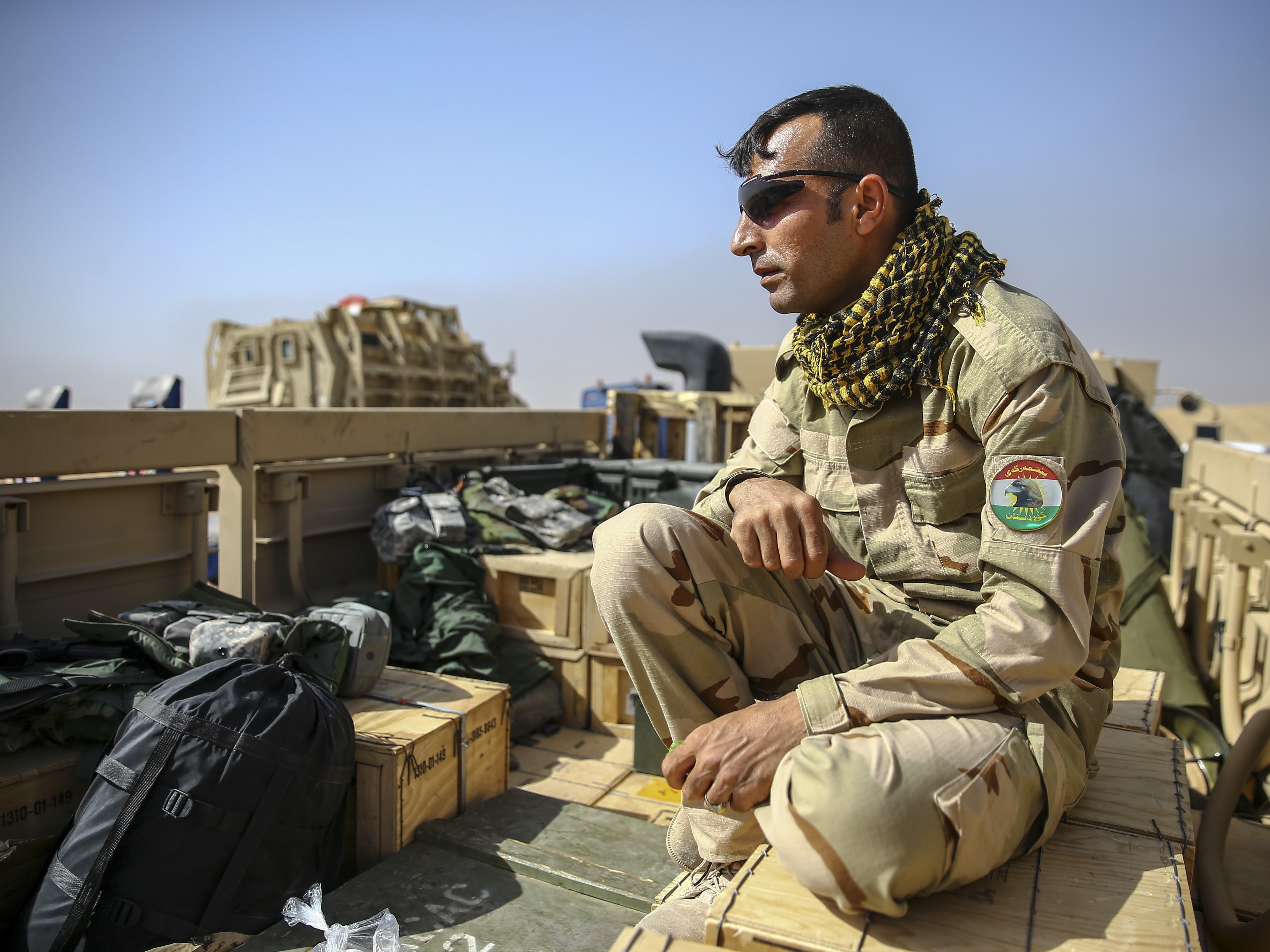 A military convoy passes through the Mahmour district as it heads toward eastern Mosul on Saturday. (Getty Images)