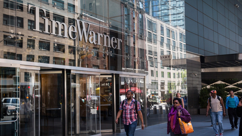 Time Warner is heading for another merger — this time with AT&T, in a deal that was announced Saturday. Here, the company's headquarters at New York City's Columbus Circle. (Andrew Burton/Getty Images)