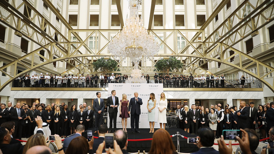 Donald Trump (center) and his family (from left), son Donald Trump Jr., son Eric Trump, wife Melania Trump and daughters Tiffany Trump and Ivanka Trump, prepare to cut the ribbon Wednesday at the Trump International Hotel Washington, D.C. (Chip Somodevilla/Getty Images)