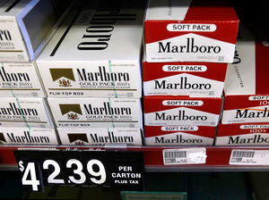 Cartons of cigarettes on shelves at Discount Smoke Shop in Ballwin, Mo., in 2012 were much cheaper than cigarettes in most other states. Missouri's tobacco tax is still only 17 cents per pack, but will rise if either of two state ballot measures passes this month.