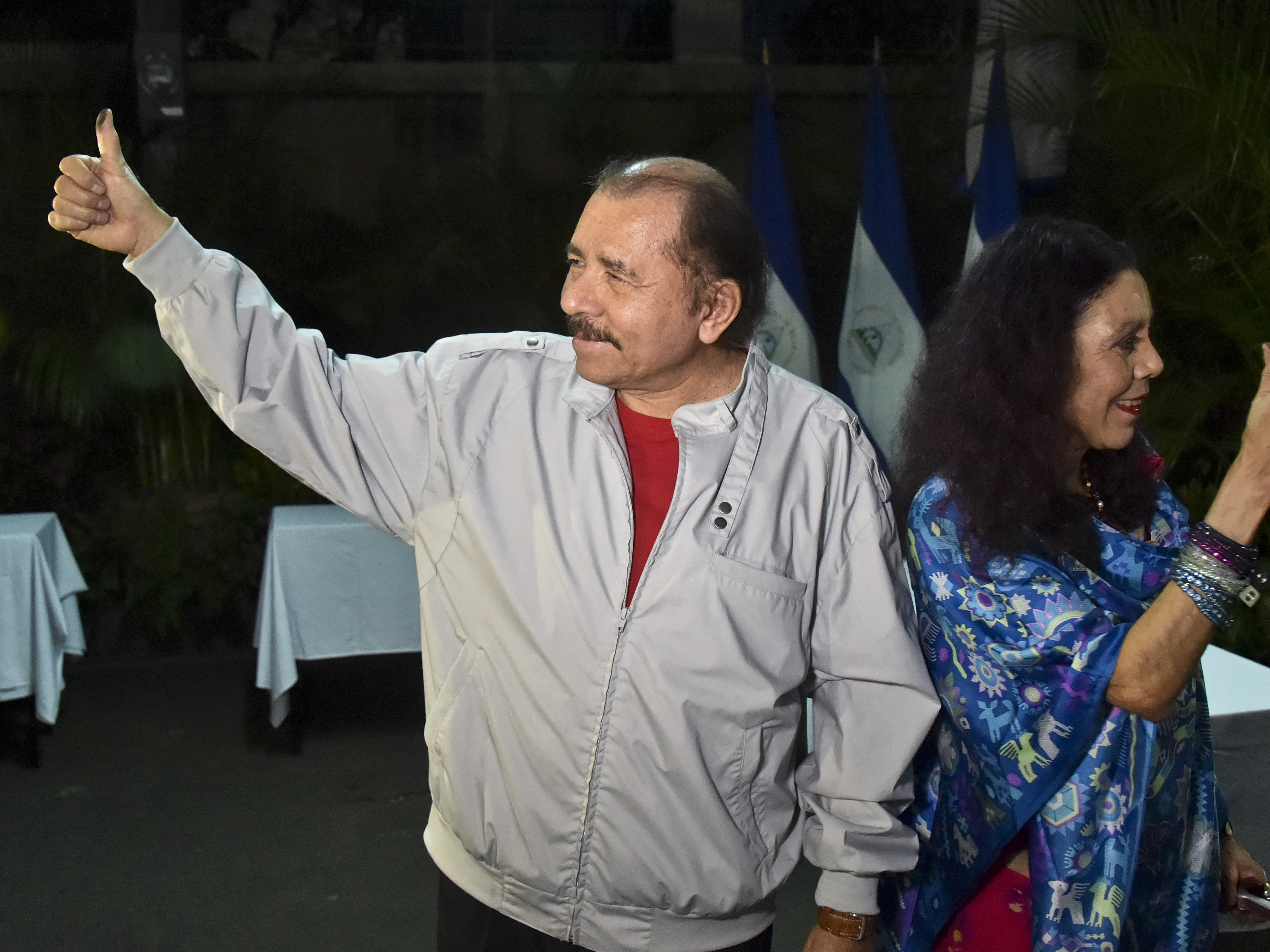 Nicaragua's President Daniel Ortega and his wife, vice presidential candidate Rosario Murillo show their marked thumbs after voting at a polling station near a their home in Managua, Nicaragua, on Sunday.