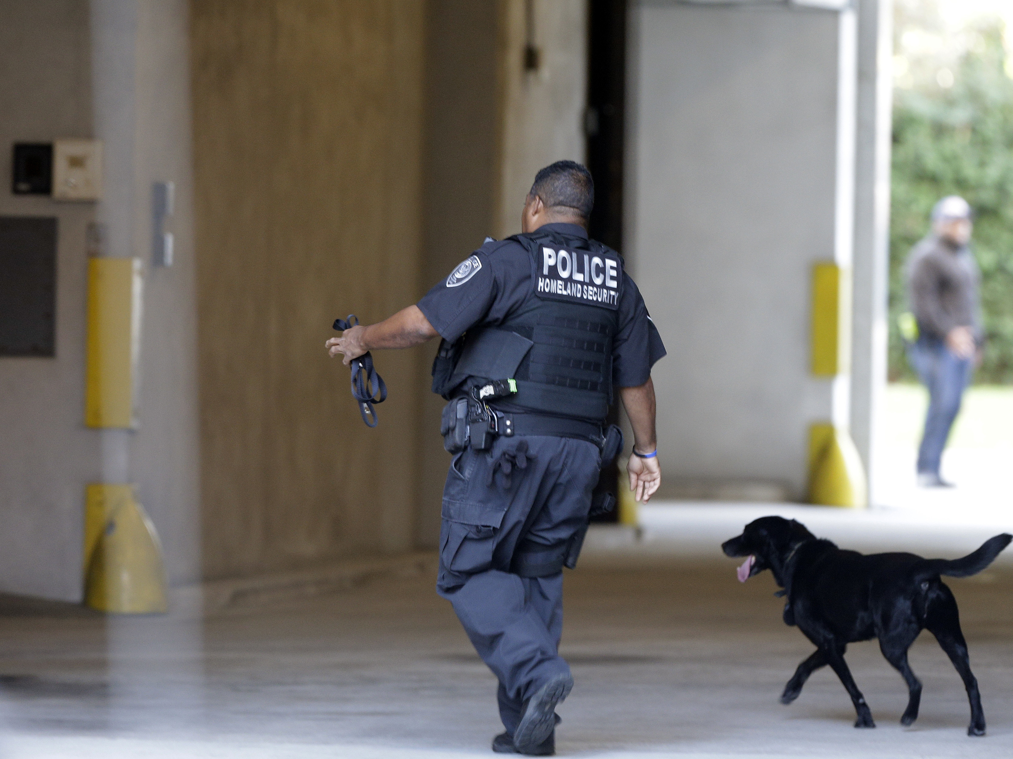 An officer with the Department of Homeland Security patrols outside the federal courthouse in Charleston, S.C., on Monday.