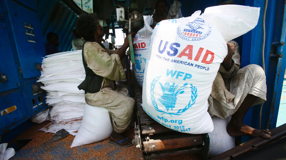 Sudanese dockers unload a U.S. aid shipment at Port Sudan on the Red Sea coast on May 5. (Ashraf Shazly/AFP/Getty Images)