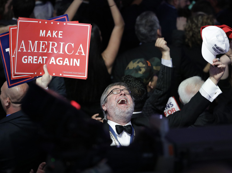 Supporters of Donald Trump react as they watch the election results during Trump's election night rally on Tuesday. (John Locher/AP)