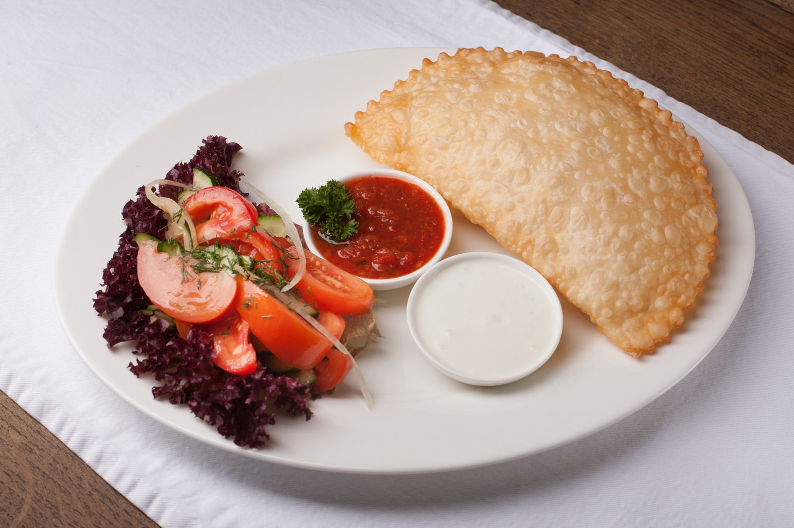 <em>Chebureki</em>, thin, deep-fried pockets of cheese, meat or mushrooms, are a best seller at Musafir. The Tatar restaurant has become an asylum-seeker of sorts in Kiev, the Ukrainian capital, in the wake of Russia's annexation of Crimea. (Courtesy of Musafir)