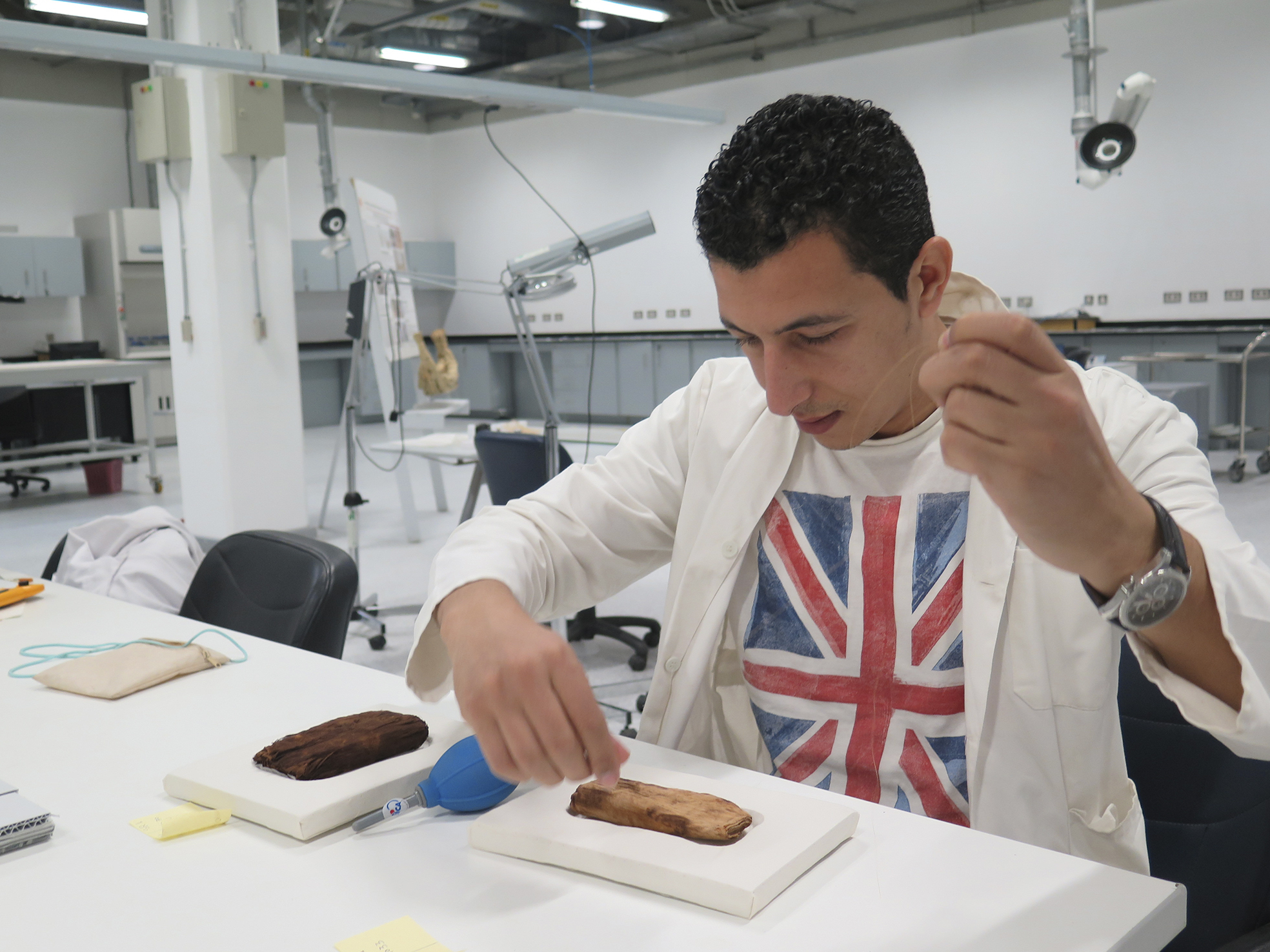 Members of the museum staff restore King Tut's leather sandals (left) and linen underwear (right).