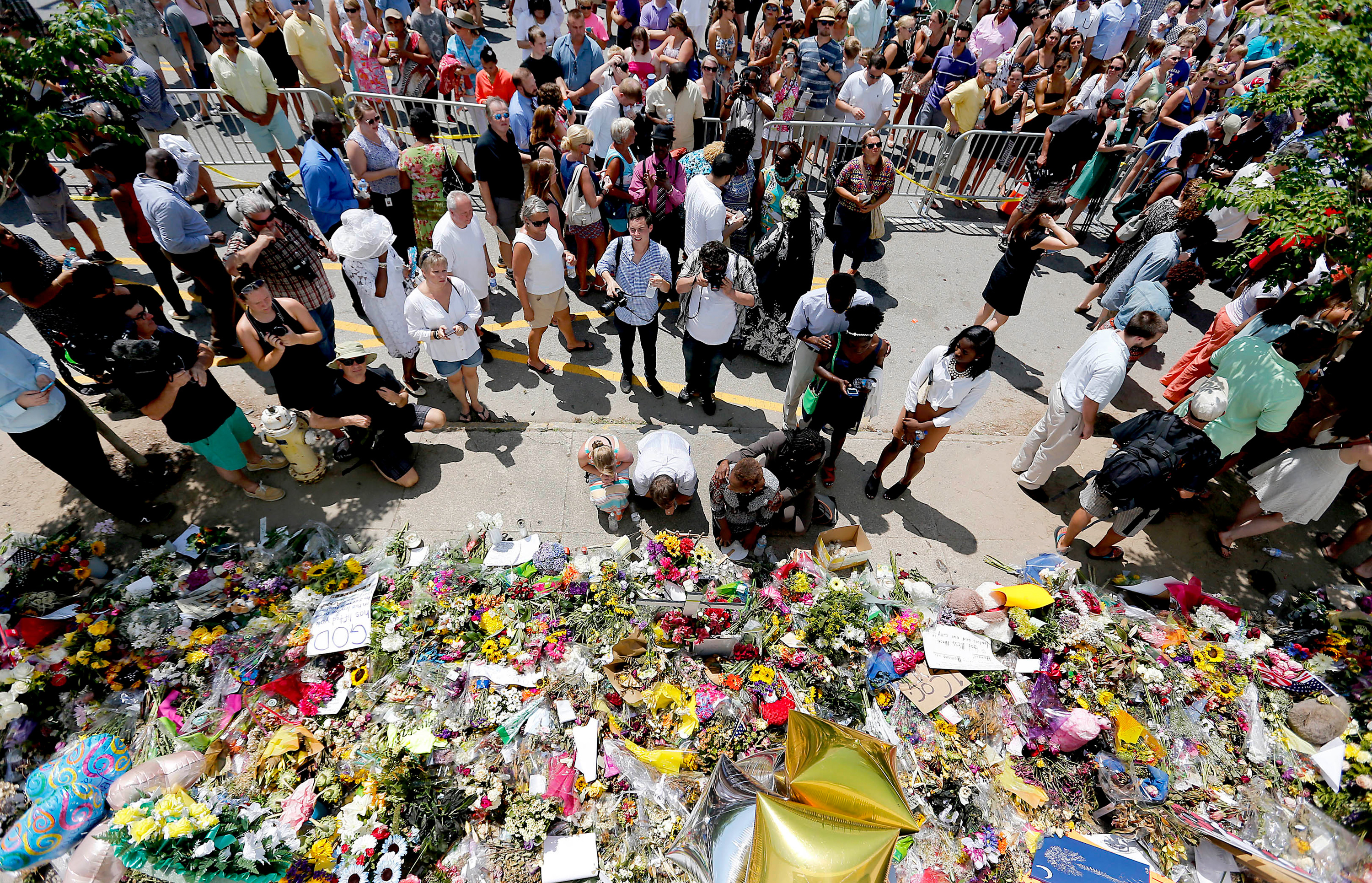 People pay respects outside of Emanuel African Methodist Church in June 2015 after a mass shooting that claimed the lives of nine people in Charleston, South Carolina. (Pool/Getty Images)