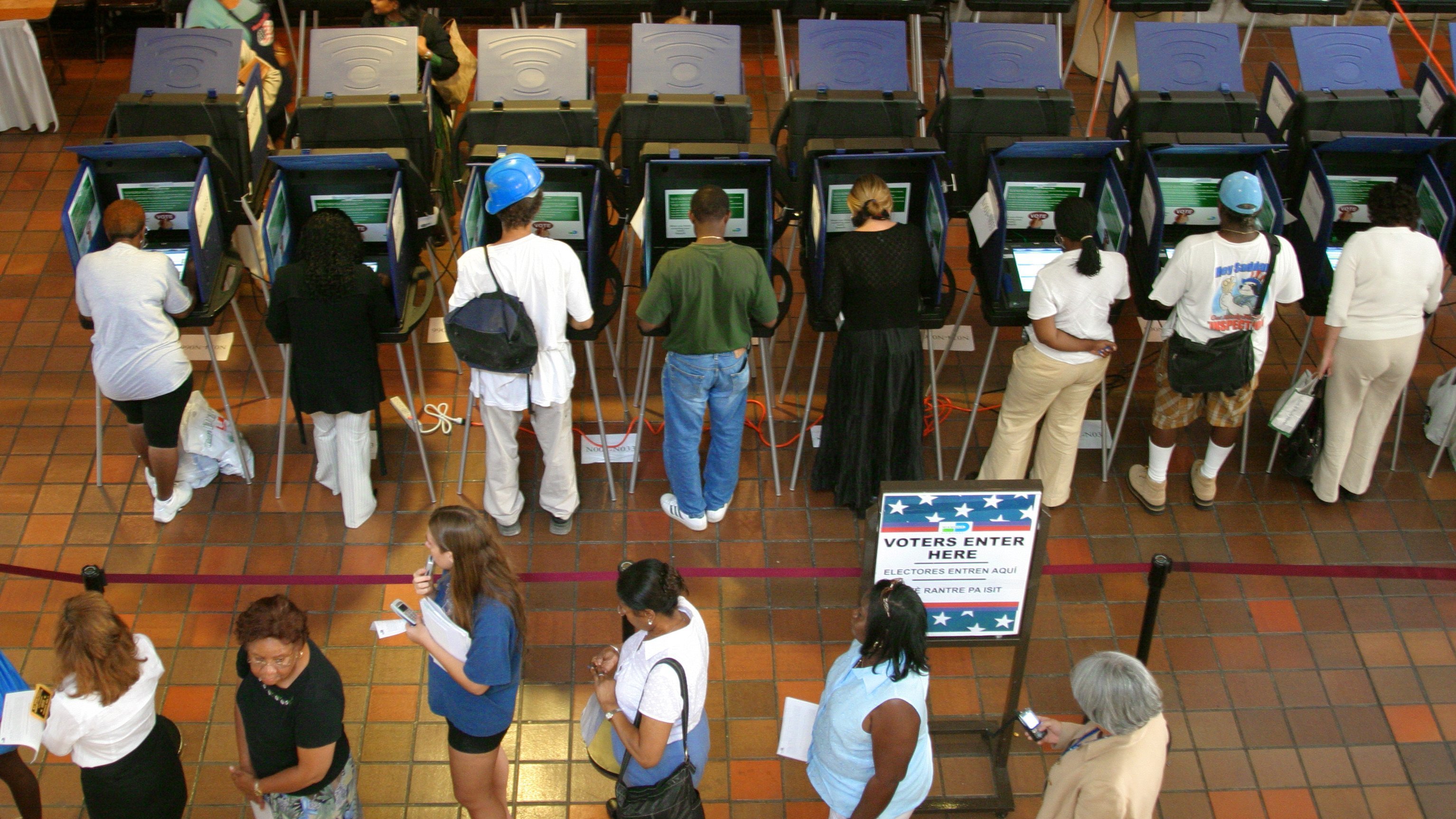 Miami voters make their choices at touch-screen voting machines. (UIG via Getty Images)