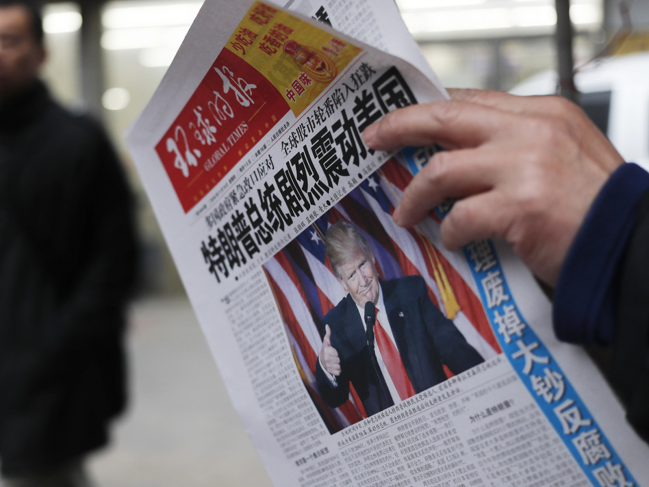 A Chinese newspaper headline says "U.S. President-elect Donald Trump delivers a mighty shock to America." Trump has promised to label China a currency manipulator, which would pave the way to imposing high tariffs on Chinese imports. (Andy Wong/AP)