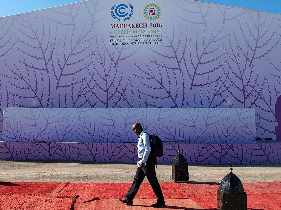 A man walks past the logo of the COP22 international climate conference on Nov. 9 in Marrakech, Morocco.