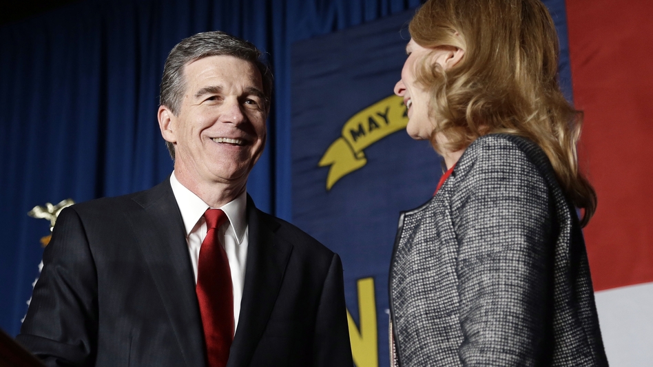 Democratic challenger Roy Cooper has a lead of more than 6,000 votes over Gov. Pat McCrory. He's seen here with his wife, Kristin, at an election night rally in Raleigh. (Gerry Broome/AP)