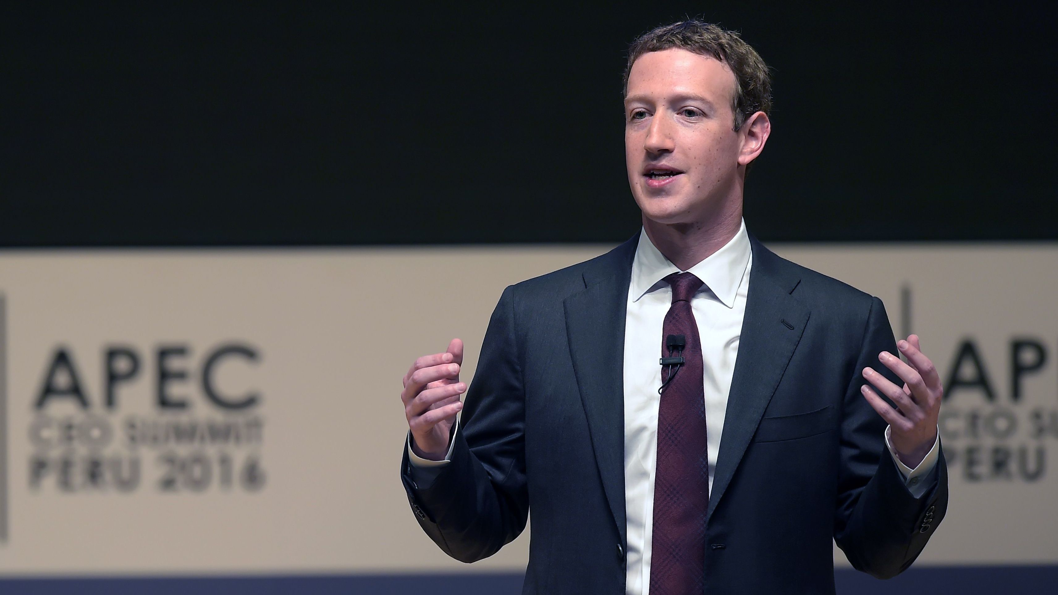 Facebook CEO Mark Zuckerberg says his company is responding to sharp criticisms over fake stories appearing in its news feeds. He's seen here speaking Saturday at the APEC CEO Summit, part of the broader Asia-Pacific Economic Cooperation (APEC) Summit in Lima. (AFP/Getty Images)