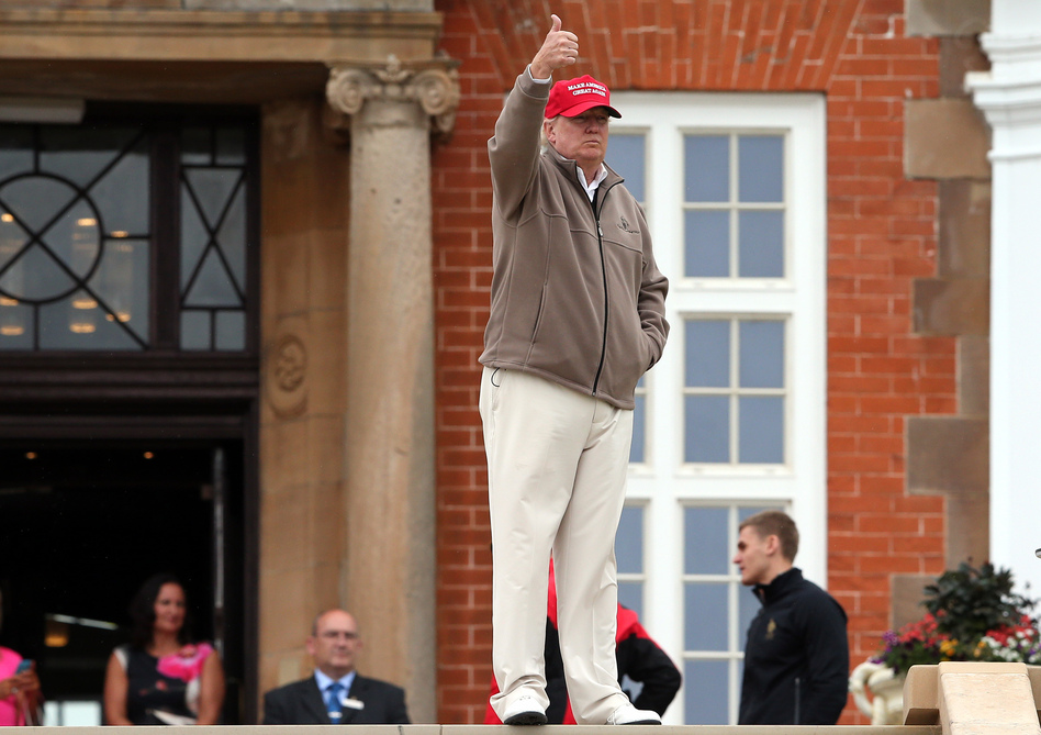 President-elect Donald Trump gestures during a visit to the golf course he owns in Turnberry, Scotland, on July 31, 2015. As president, Trump will face foreign policy decisions that are likely to have an impact on his extensive international holdings, but he says he has no plans to sell his foreign business interests. (Scott Heppell/AP)