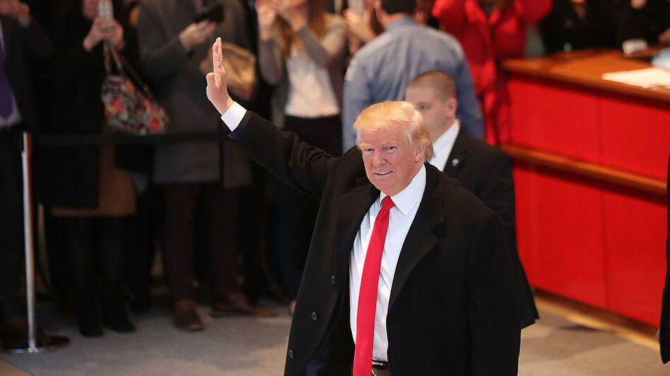 President-elect Donald Trump walks through the lobby of <em>The New York Times</em> building following a meeting with editors at the paper last week. (Spencer Platt/Getty Images)
